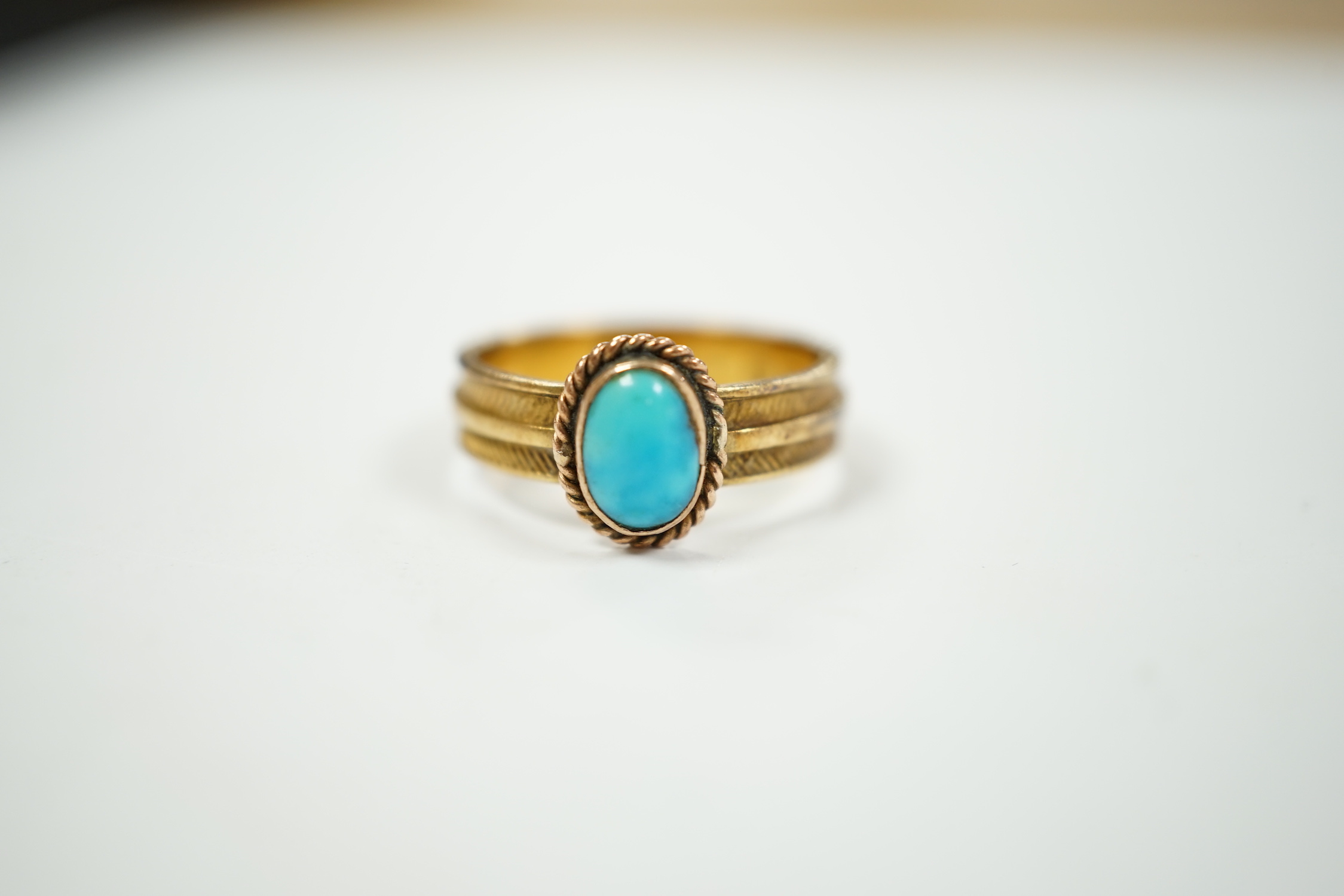 An 18ct gold and singe stone cabochon turquoise set ring, size K/L, gross weight 3.4 grams.